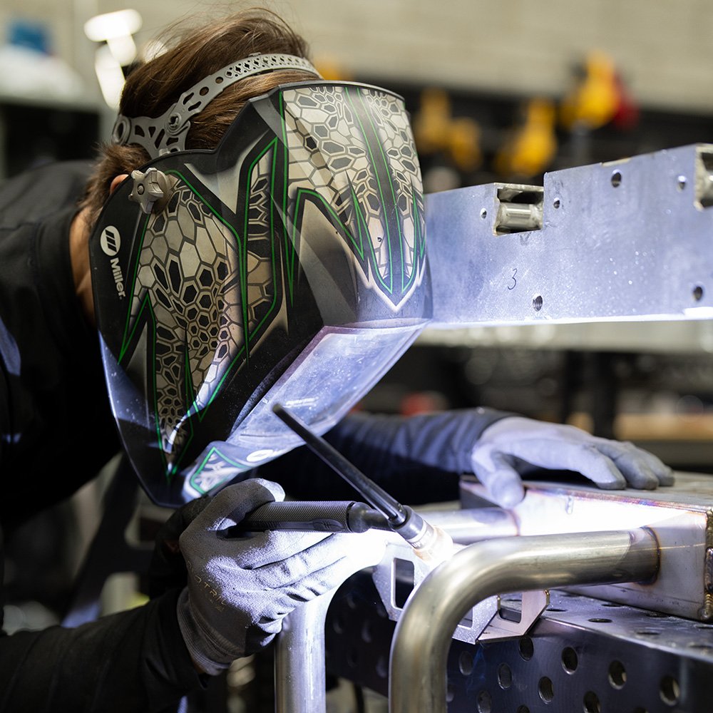 Welder fabricating metal components on site