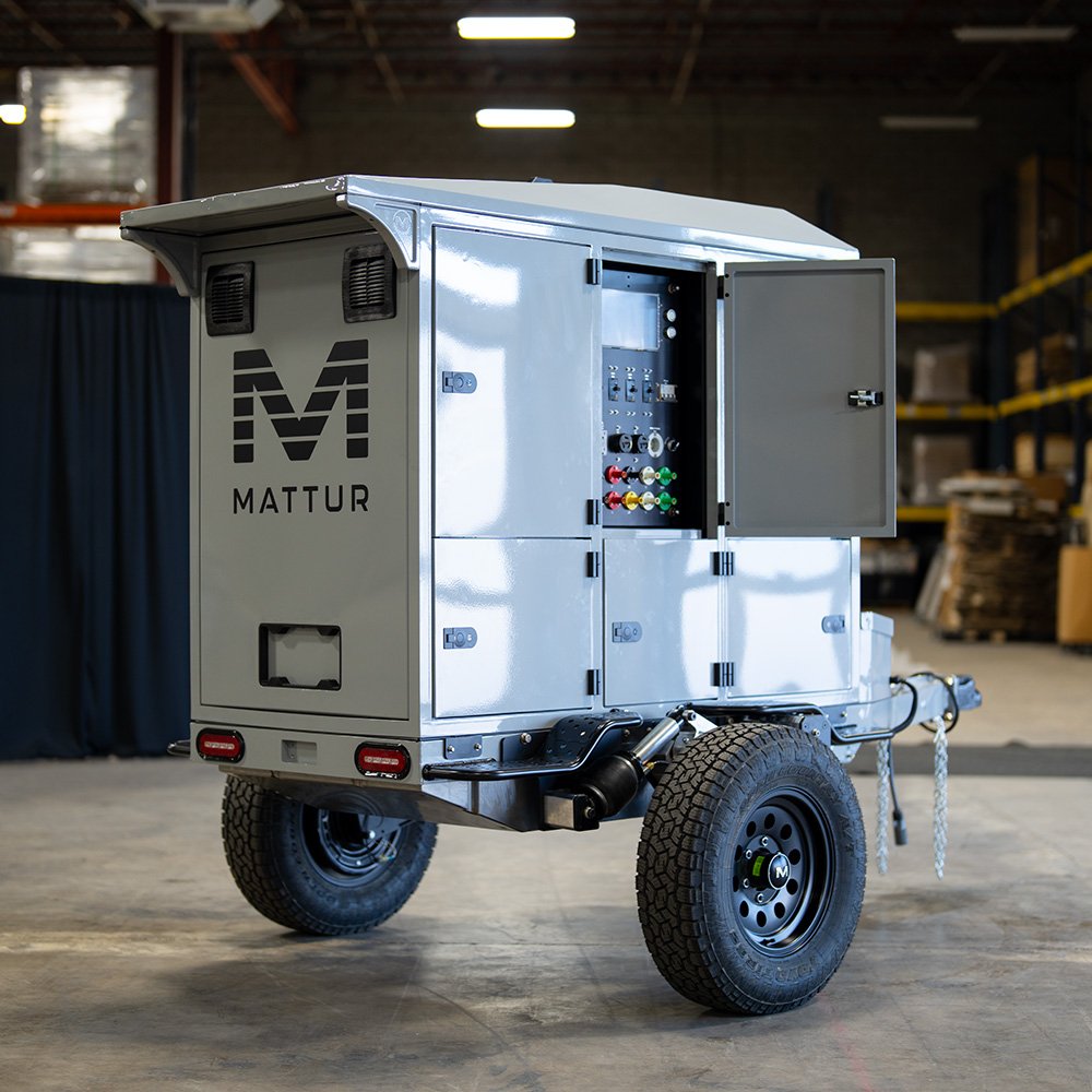 Mattur trailer unit with open control panel in a workshop