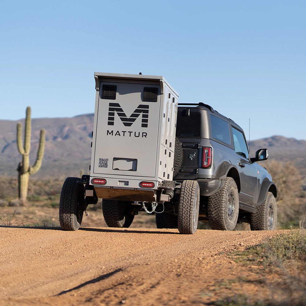 Mattur trailer towed by an SUV on a desert road